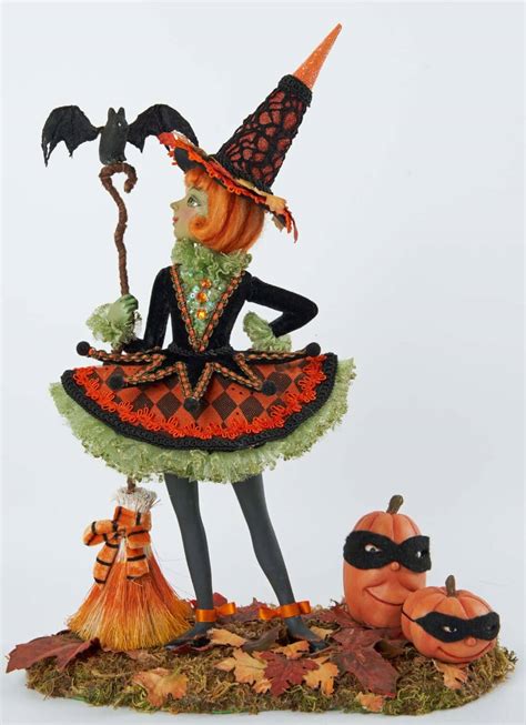 Witch figurine holding stakes for halloween